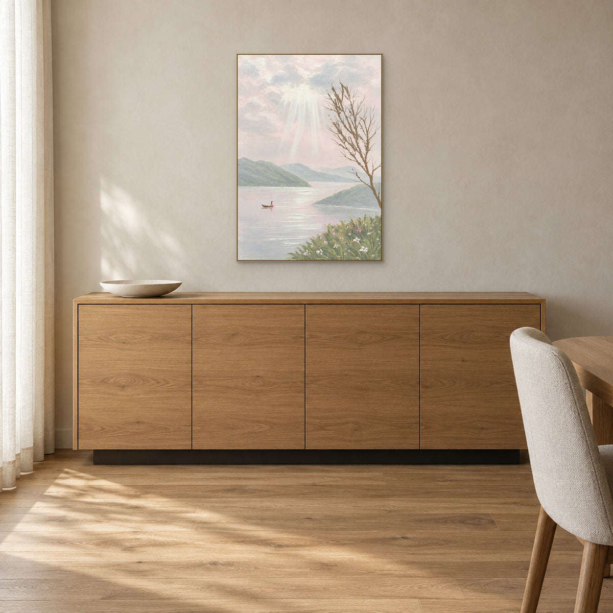 Lake landscape with a flower-lined shore in a champagne-tone frame above an oak sideboard
