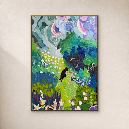 Black cat among blue-green foliage and pink flowers, in a thin gold-toned floating frame on a continuous ivory wall