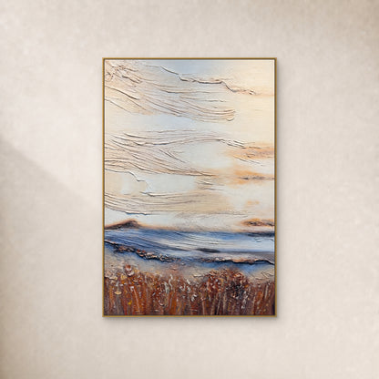 Tableau abstrait texturé ivoire, bande bleue basse et base brun rouille, dans un fin cadre doré sur un mur ivoire