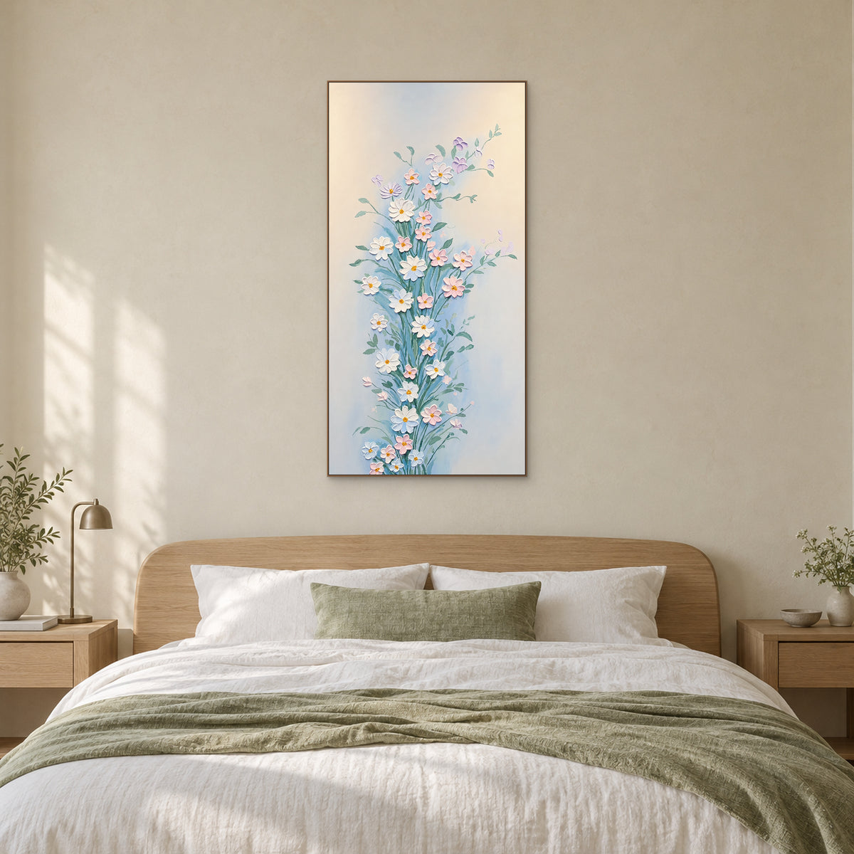 Tableau élancé de fleurs blanches et roses dans un cadre ton chêne, centré au-dessus d’un lit tapissé