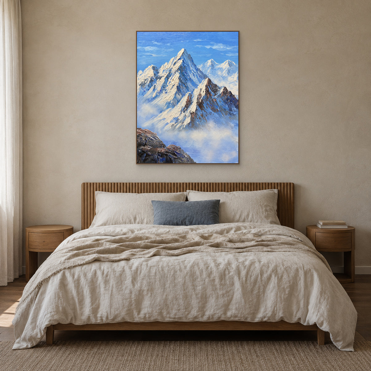 Tableau de montagnes enneigées, cadre couleur chêne centré au-dessus d’un lit en lin