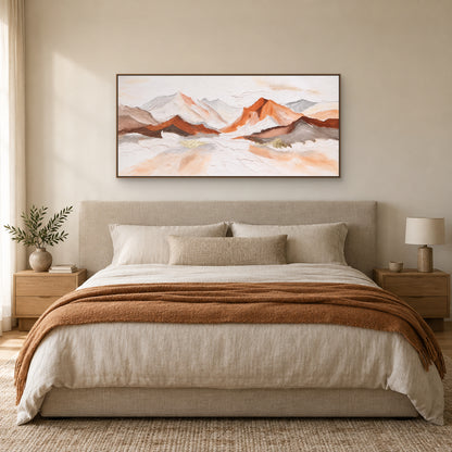 Panoramic mountain painting in an oak-tone floating frame above an oatmeal headboard and rust-coloured throw