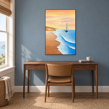 Vertical coastal painting in a black frame above a walnut desk and tan chair against a dusty-blue wall