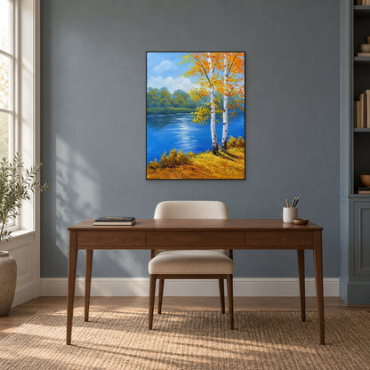Tableau de rivière bleue et de bouleaux dorés à fin cadre noir, au-dessus d’un bureau en bois