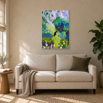 Vertical cat garden painting in a white floating frame above an ivory two-seat settee beside a reading table
