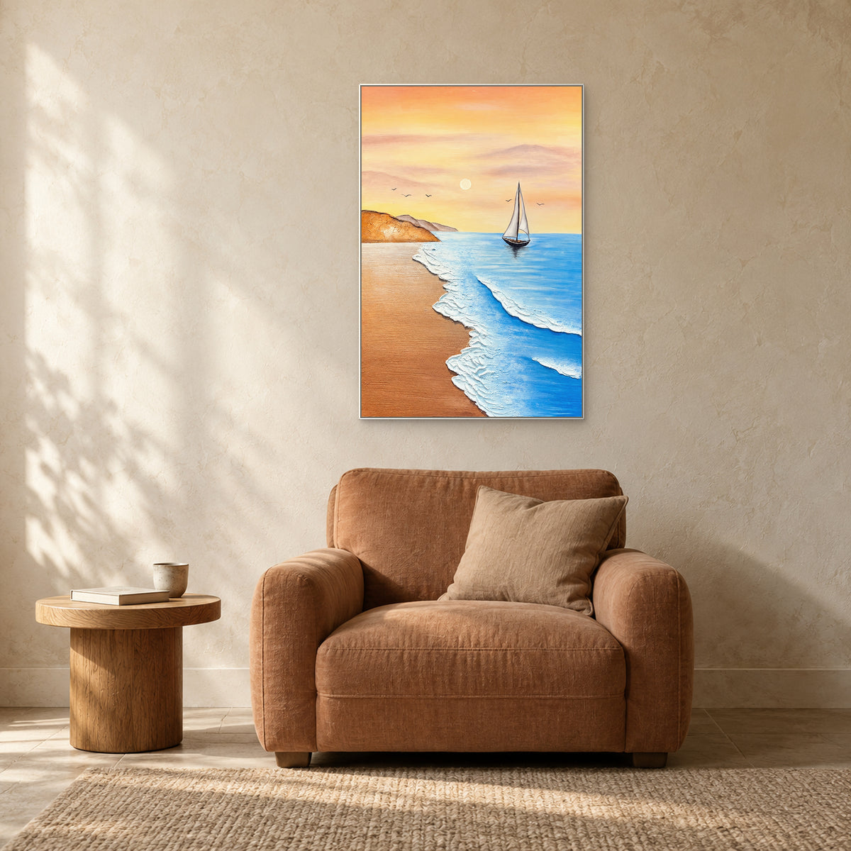 White-sail coastal painting in a white frame above a terracotta armchair beside a small round table