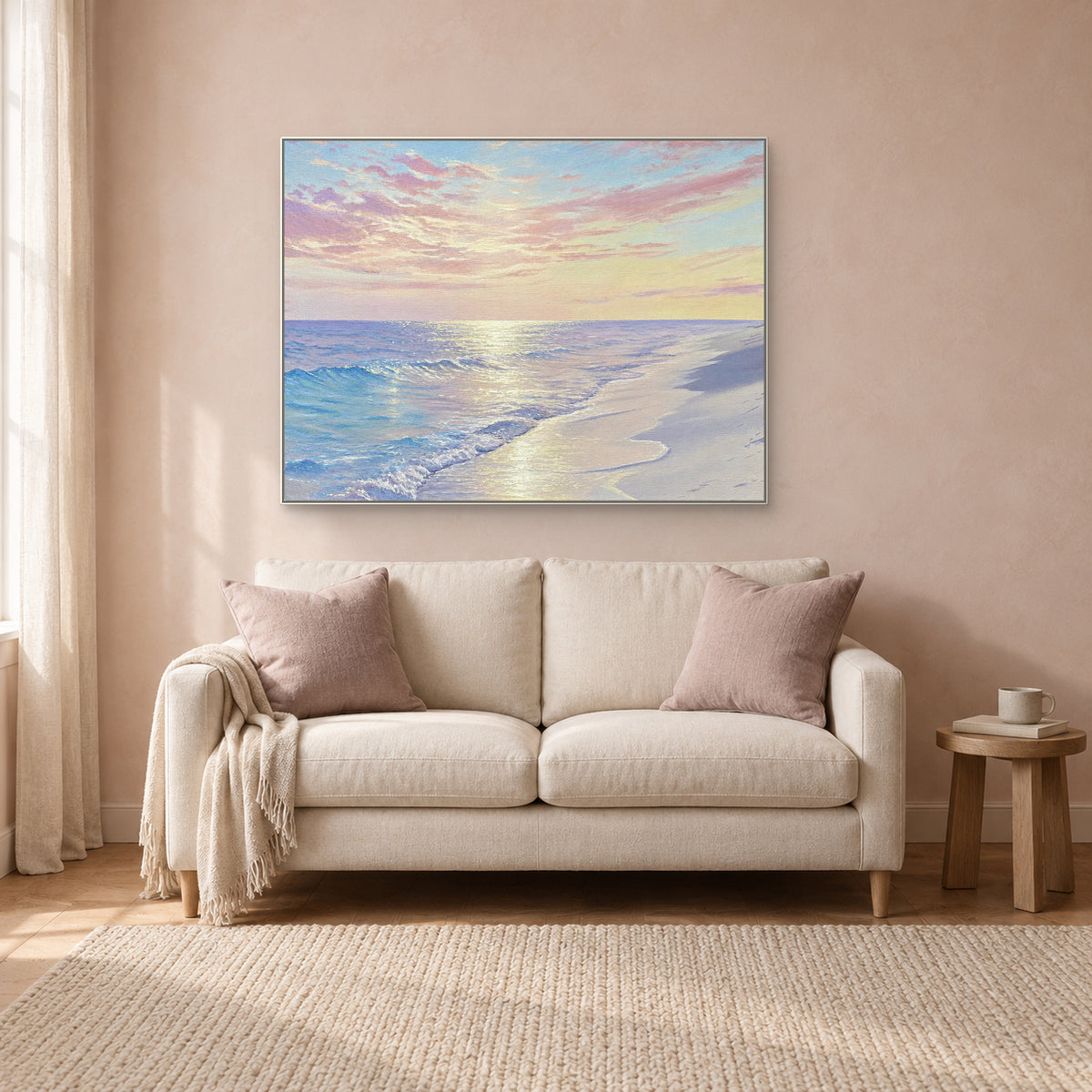 Pastel shoreline painting in a slim white frame above a cream settee against a muted pink wall