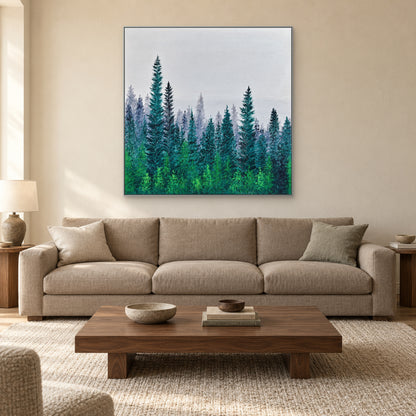 Silver-tone framed square forest painting above a taupe sofa with a low wooden coffee table