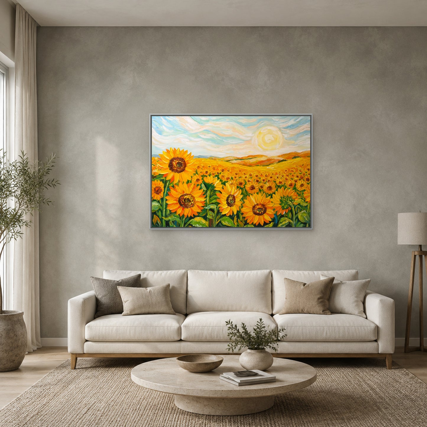 Sunflower field painting in a slim silver floating frame above a cream sofa on a muted sage-grey wall