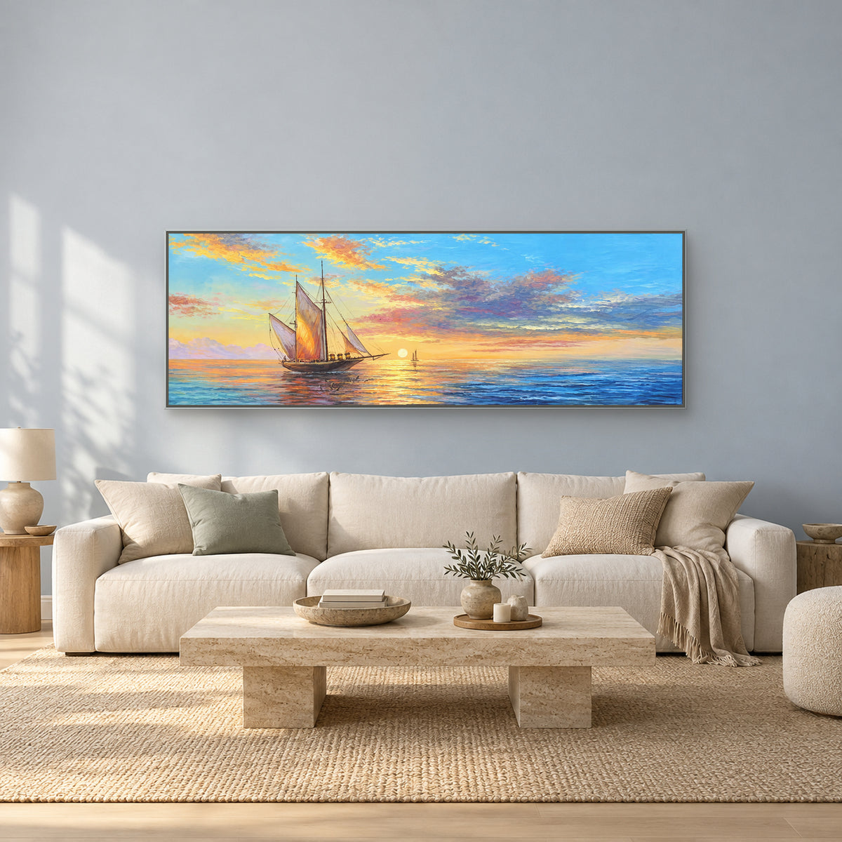 Blue and gold panoramic seascape in a silver-tone frame over an ivory sofa