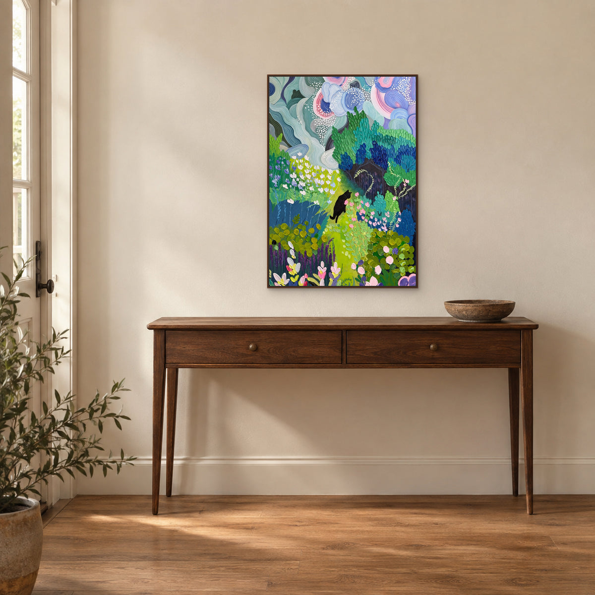 The Cat’s Garden painting in a walnut-toned floating frame centred above a two-drawer entryway console