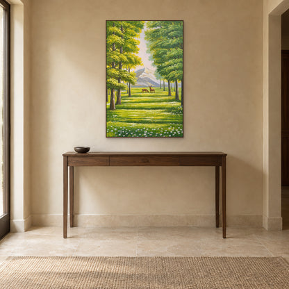Sunlit green forest and deer wall art in a walnut-tone floating frame above a slim entry console