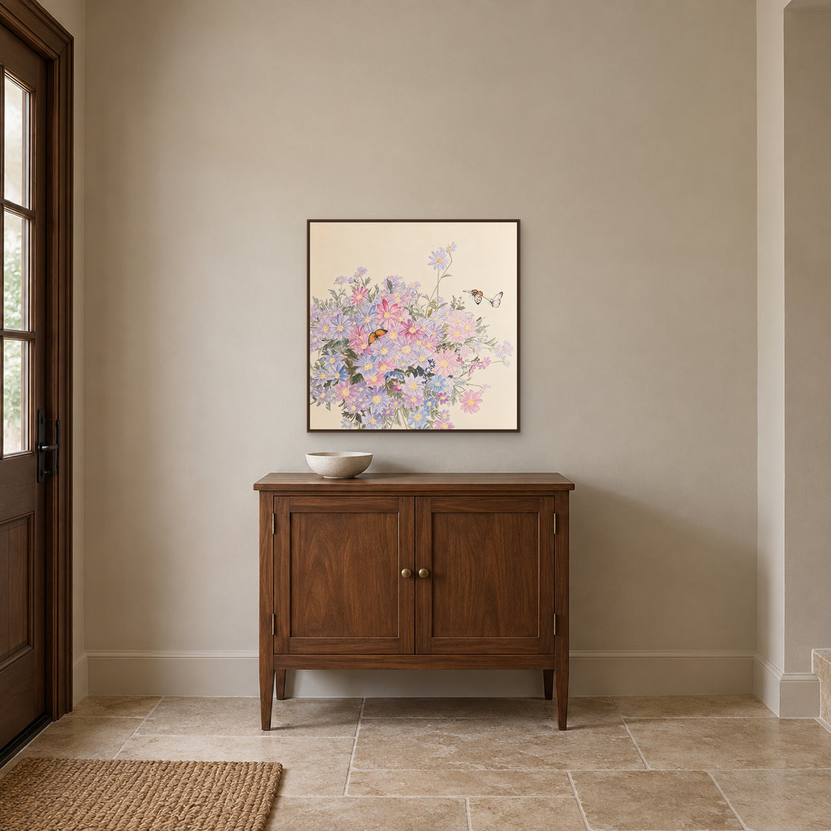Butterflies and pale flowers in a walnut-look floating frame above an entryway cabinet