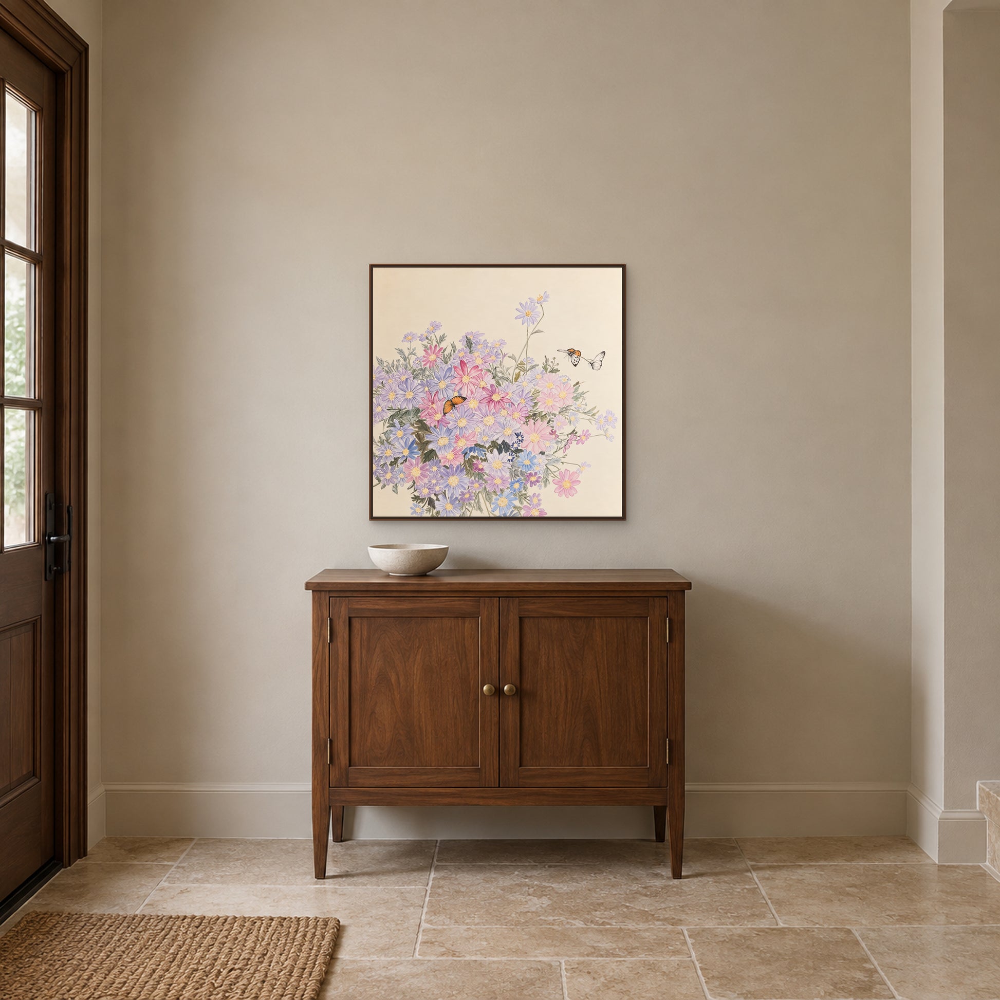 Butterflies and pale flowers in a walnut-look floating frame above an entryway cabinet
