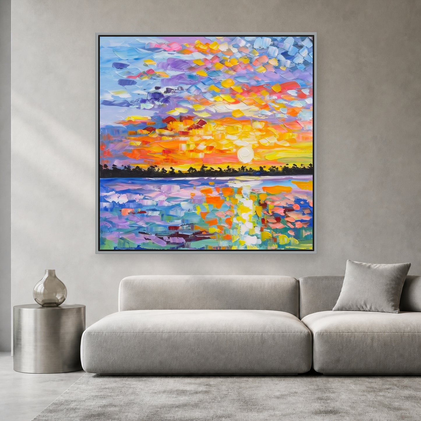 Colorful square sunset painting in a slim silver floating frame above a light gray sofa