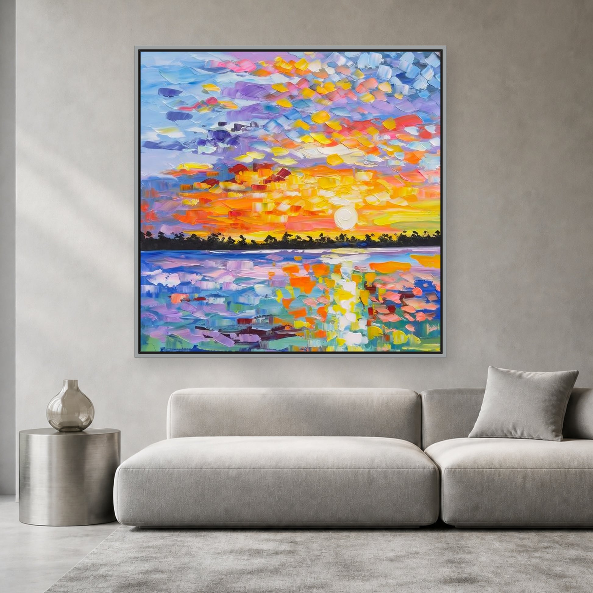 Colorful square sunset painting in a slim silver floating frame above a light gray sofa