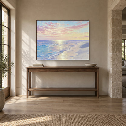 Shore of Light beach painting in a walnut-tone frame above an entryway console with a low bowl and books
