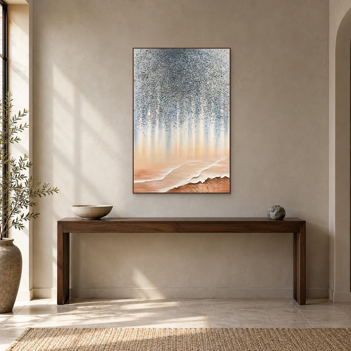 Stardust Shore in a walnut-toned frame above a dark wood entryway console, with a low bowl and small stone-like ornament
