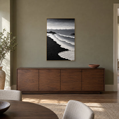 Tableau marin vertical noir et blanc dans un cadre flottant champagne, au-dessus d’un buffet ton noyer contre un mur gris olive de salle à manger