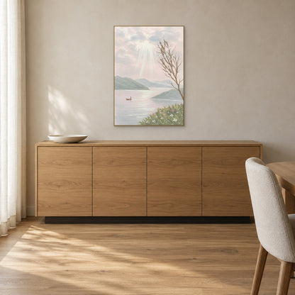 Lake landscape with a flower-lined shore in a champagne-tone frame above an oak sideboard