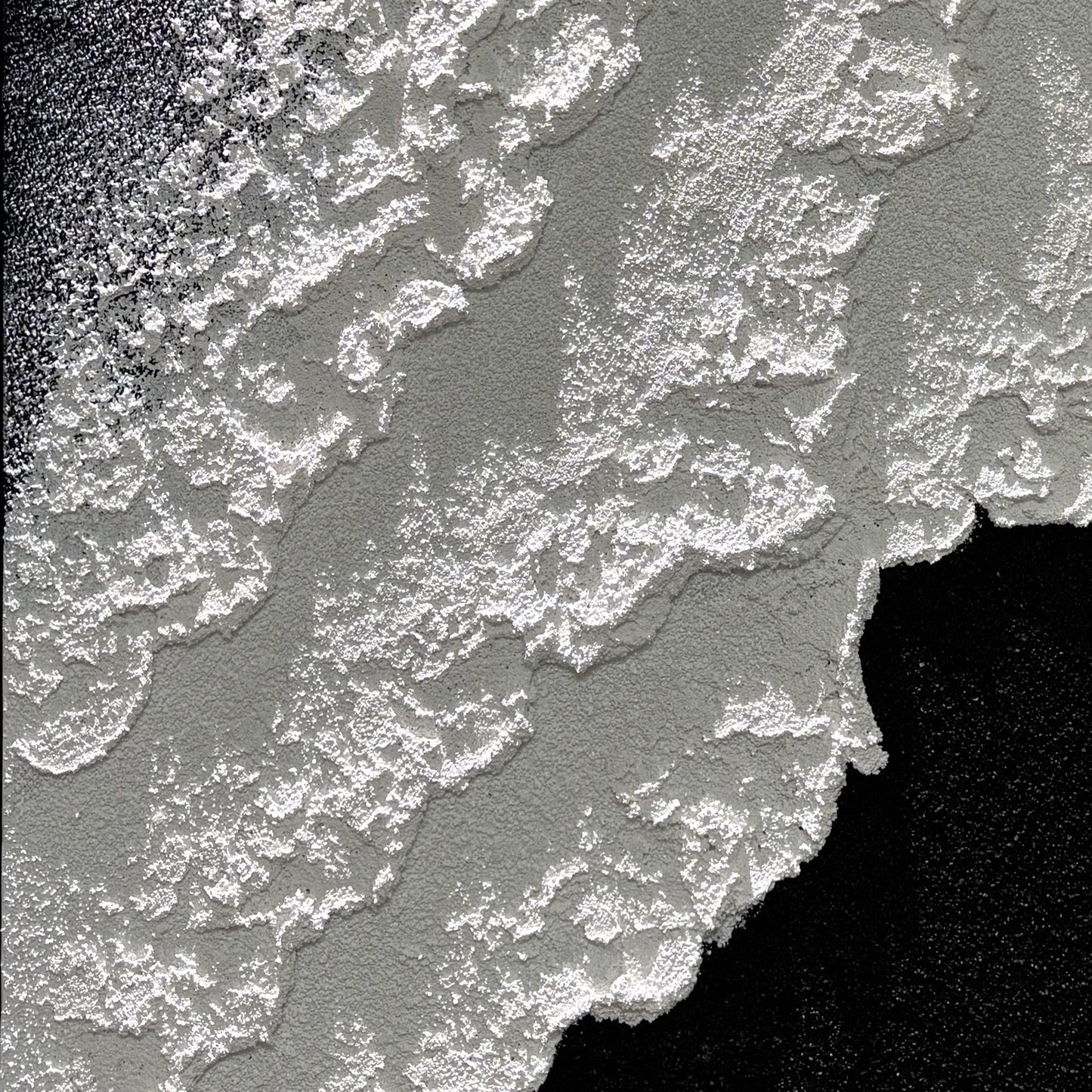 Close view of Vestige of Silence raised edges in directional light