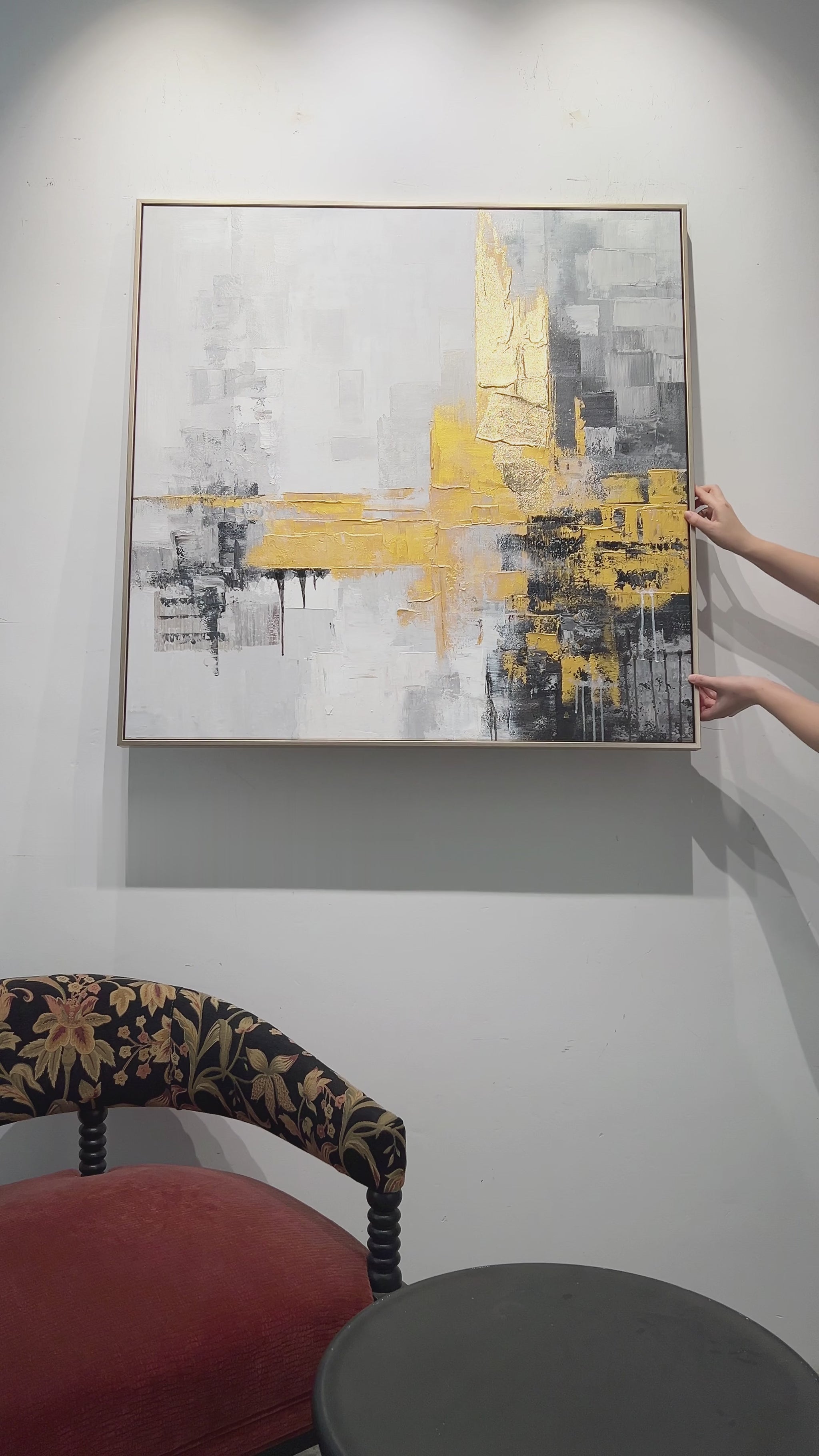 Hanging a square grey and gold abstract, followed by surface details, a hand demonstration and the finished dining-room display