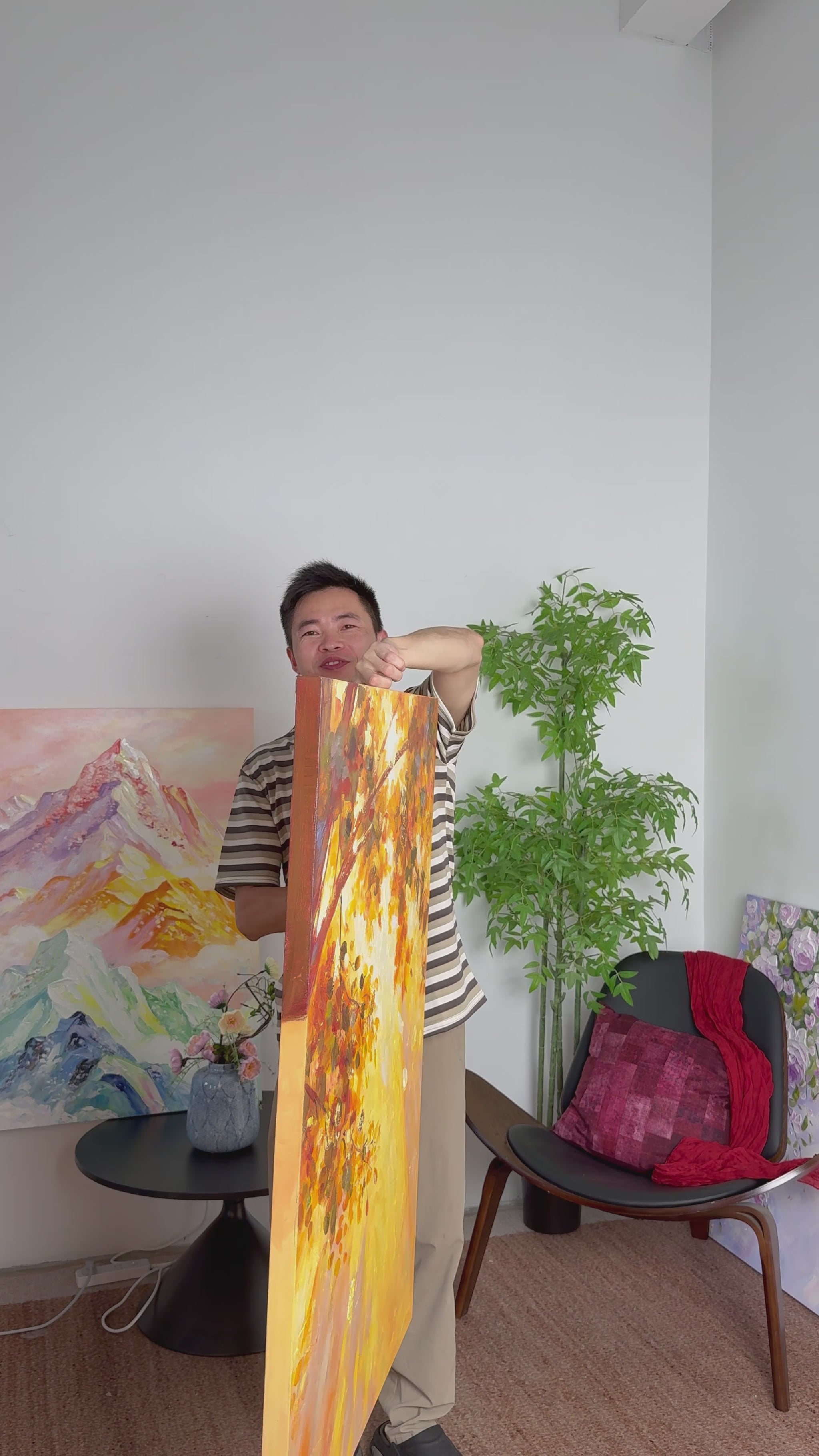 The autumn tree painting turns into frontal view, followed by its complete framed presentation on an ivory wall.
