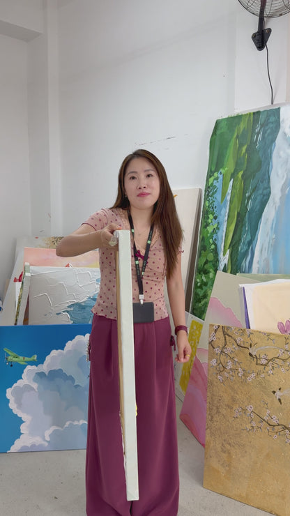 A yellow blossom painting turned towards the camera, followed by a gold-framed view on an ivory wall