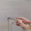 An artist builds and colours the textured surface of a coastal painting, with original sound.