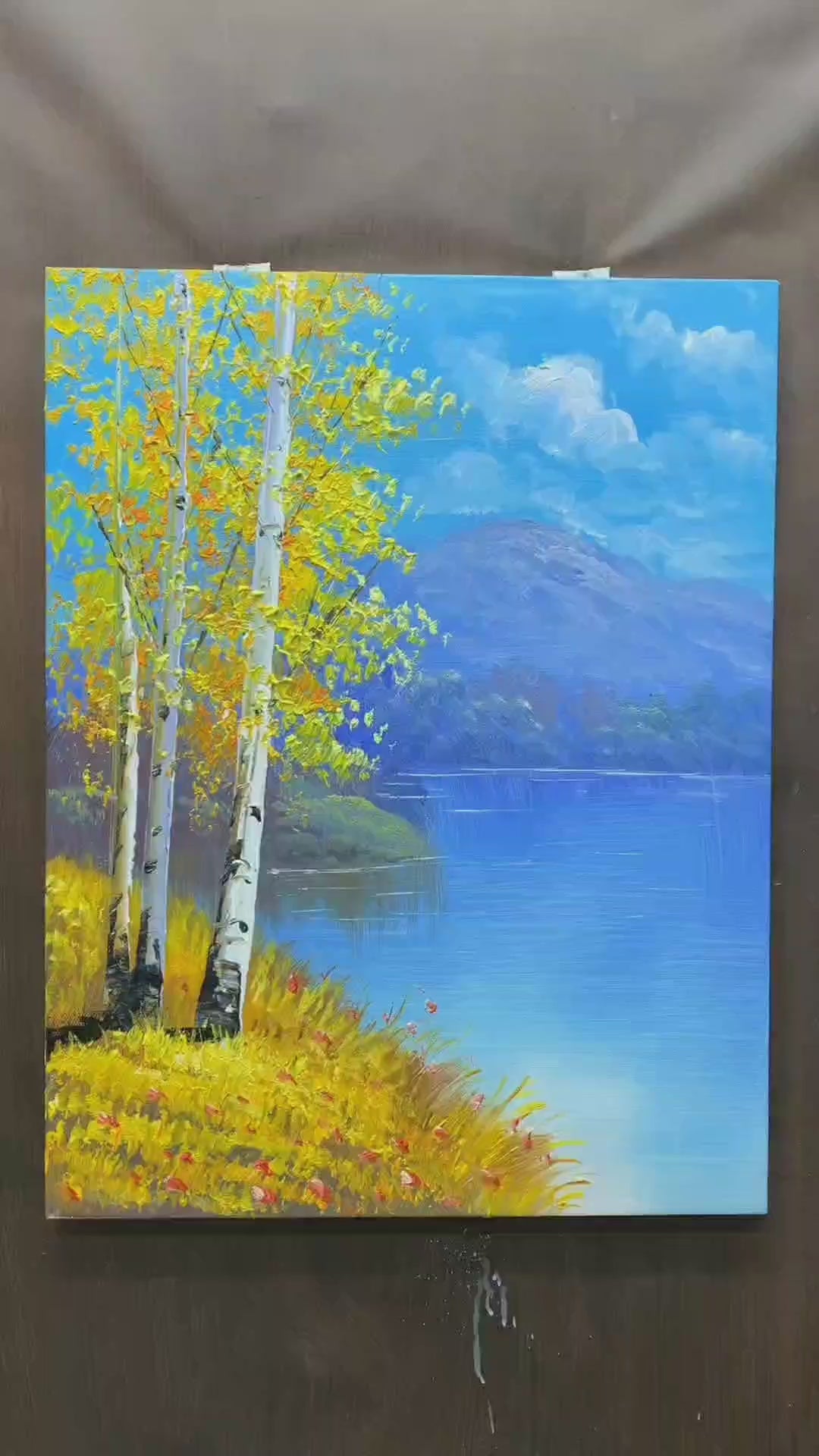 Painting golden birch foliage, white trunks, clouds and a flower-dotted lakeshore, followed by the finished landscape.