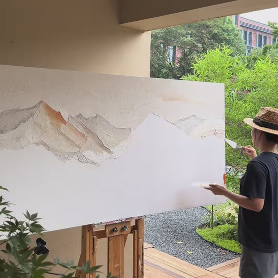 Brushes build pale and copper mountain ridges, followed by finished texture details and the painting outdoors